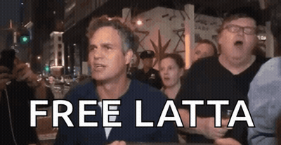 A Man In A Crowd Says Free Latta In Front Of A Police Officer . GIF