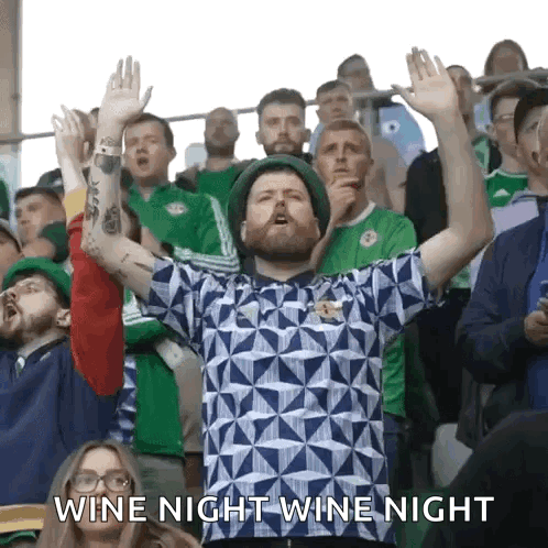 A Man In A Crowd With His Hands In The Air And The Words Wine Night Wine Night GIF