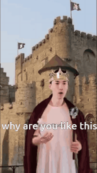 A Man In A Crown And Cape Is Standing In Front Of A Castle Holding A Sword . GIF
