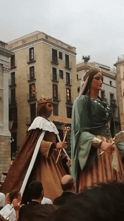 A Man In A Crown Stands Next To A Woman In A Dress GIF