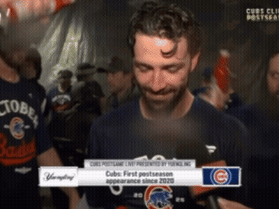 A Man In A Cubs Shirt Is Being Interviewed By A Reporter GIF