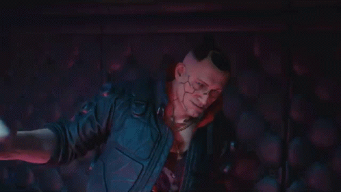 A Man In A Cyberpunk Suit Is Holding A Woman 'S Hand In A Dark Room . GIF