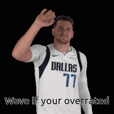 A Man In A Dallas 77 Jersey Is Waving His Hand GIF