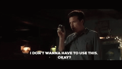 A Man In A Dark Room Is Saying " I Don T Wanna Have To Use This Okay " GIF