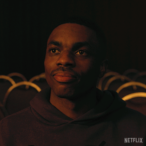 A Man In A Dark Room With A Netflix Logo In The Corner GIF