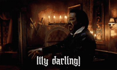 A Man In A Dark Room With Candles And The Words My Darling GIF
