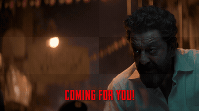 A Man In A Dark Room With The Words " Coming For You " On The Bottom GIF