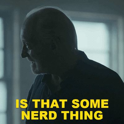 A Man In A Dark Room With The Words " Is That Some Nerd Thing " Above Him GIF