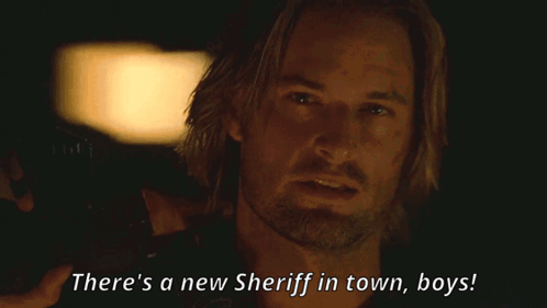 A Man In A Dark Room With The Words There 'S A New Sheriff In Town Boys GIF