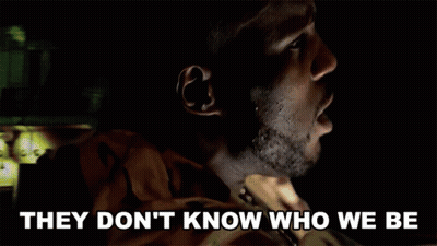 A Man In A Dark Room With The Words They Don 'T Know Who We Be Below Him GIF