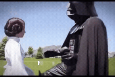 A Man In A Darth Vader Costume Is Standing Next To A Woman In A White Dress In A Field . GIF