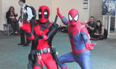 A Man In A Deadpool Costume And A Man In A Spiderman Costume Are Dancing Together . GIF