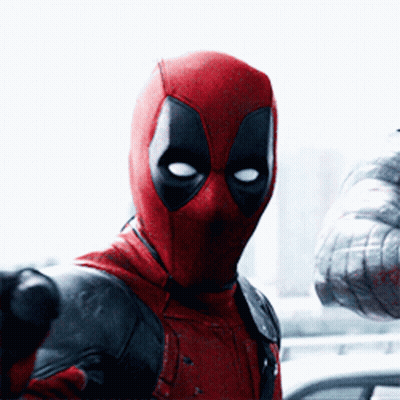 A Man In A Deadpool Costume Holds A Gun GIF