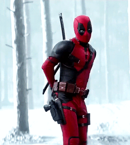 A Man In A Deadpool Costume Holds A Gun GIF