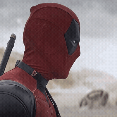 A Man In A Deadpool Costume Holds A Sword In His Hand GIF