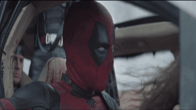 A Man In A Deadpool Costume Is In A Car GIF