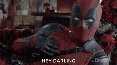 A Man In A Deadpool Costume Is Laying On A Bed And Saying Hey Darling GIF