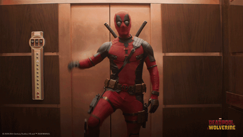 A Man In A Deadpool Costume Is Standing In A Elevator GIF
