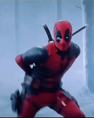 A Man In A Deadpool Costume Is Standing In A Room With A Sword On His Shoulder . GIF