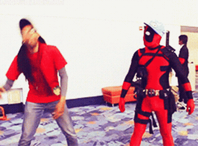 A Man In A Deadpool Costume Is Standing Next To A Man In A Red Shirt GIF