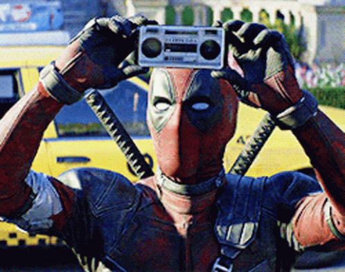 A Man In A Deadpool Costume Is Taking A Picture Of Himself With A Boombox GIF