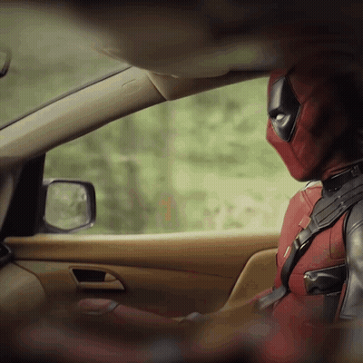 A Man In A Deadpool Costume Sits In A Car GIF