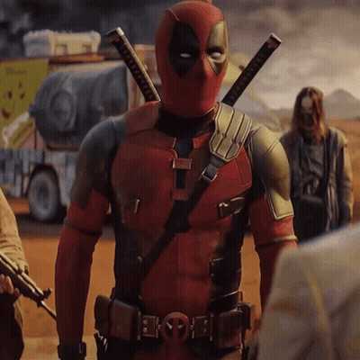 A Man In A Deadpool Costume Stands In A Desert GIF