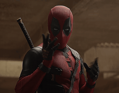 A Man In A Deadpool Costume With A Sword Behind His Back GIF
