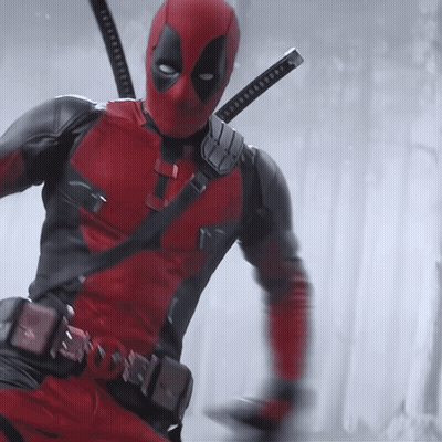 A Man In A Deadpool Costume With Two Swords On His Shoulder GIF