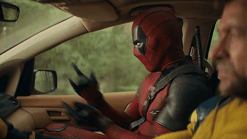 A Man In A Deadpool Suit Is Sitting In A Car GIF