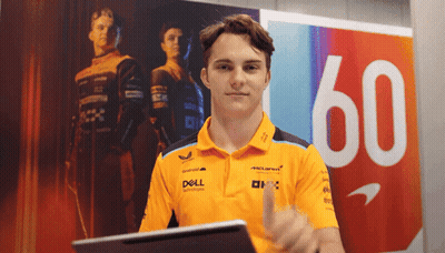 A Man In A Dell Shirt Giving A Thumbs Up In Front Of A Sign With The Number 60 GIF