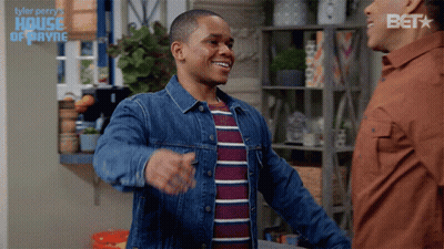 A Man In A Denim Jacket Is Hugging Another Man In A House Of Payne Advertisement GIF