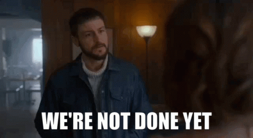 A Man In A Denim Jacket Says " We 'Re Not Done Yet " To A Woman GIF