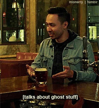 A Man In A Denim Jacket Sits At A Bar With A Mug Of Beer And Talks About Ghost Stuff GIF