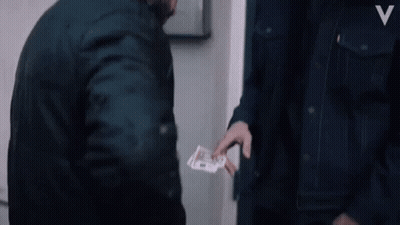 A Man In A Denim Jacket With The Letter V On The Front GIF