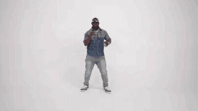 A Man In A Denim Shirt And Jeans Is Dancing In Front Of A White Background . GIF
