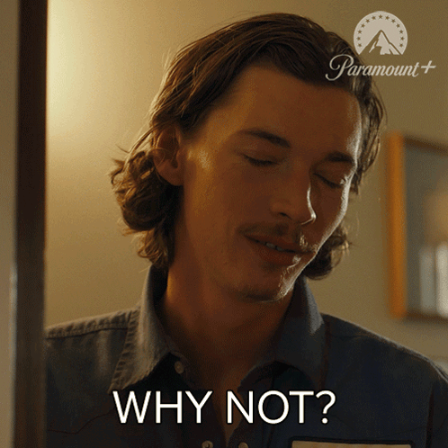 A Man In A Denim Shirt Is Asking Why Not GIF