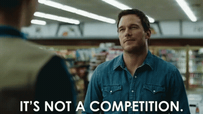 A Man In A Denim Shirt Is Saying It 'S Not A Competition GIF