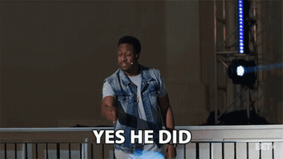 A Man In A Denim Vest Says Yes He Did While Standing On A Balcony GIF