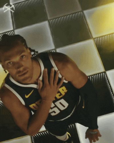 A Man In A Denver 50 Jersey Stands On A Checkerboard Floor GIF