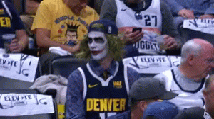 A Man In A Denver Jersey Is Sitting In A Crowd GIF