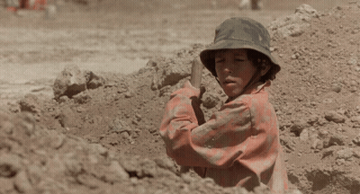 A Man In A Dirty Shirt Is Sitting On The Ground GIF