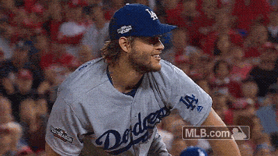 A Man In A Dodgers Jersey Is Smiling GIF