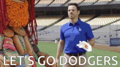 A Man In A Dodgers Shirt Is Standing On A Field GIF