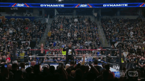 Man In Dynamite Shirt In Front Of Crowd GIF