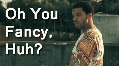 A Man In A Fancy Shirt Is Standing In Front Of A Sign That Says Oh You Fancy Huh ? GIF