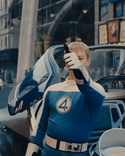 A Man In A Fantastic Four Costume Talks On A Phone GIF