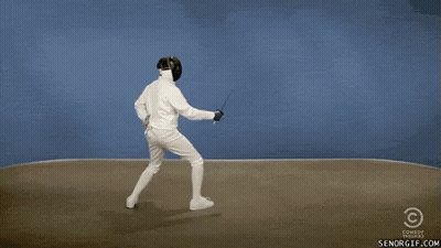 A Man In A Fencing Suit Is Holding A Sword While Another Man In A Fencing Suit Is Dancing . GIF