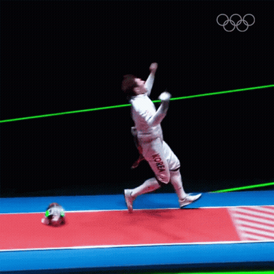 A Man In A Fencing Uniform Is Jumping In The Air With A Sword GIF