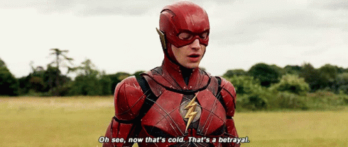 A Man In A Flash Costume Is Standing In A Field And Saying " Oh See , Now That 'S Cold . GIF